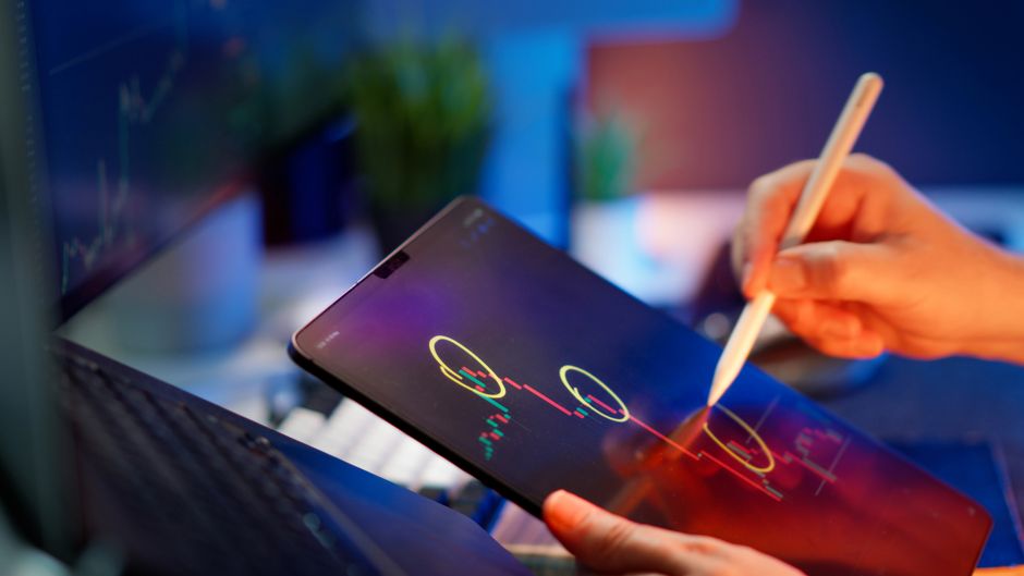 Trader reviewing market data and price movements on a tablet