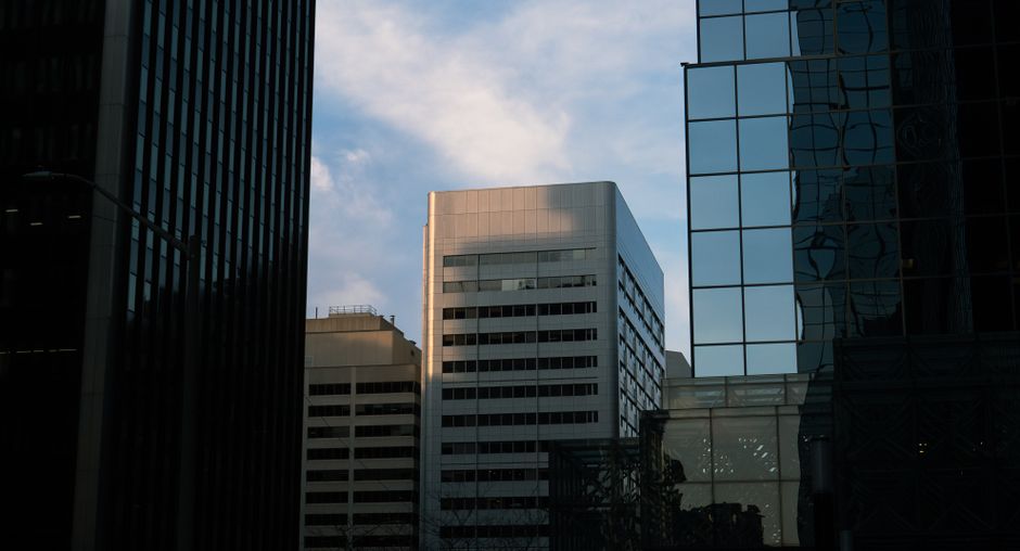 Modern cityscape of glass skyscrapers with reflections under a blue sky