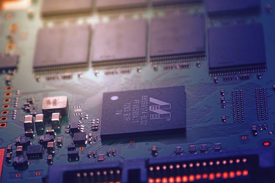 Detailed electronic circuit board showing microchips and intricate wiring in a modern technology setting
