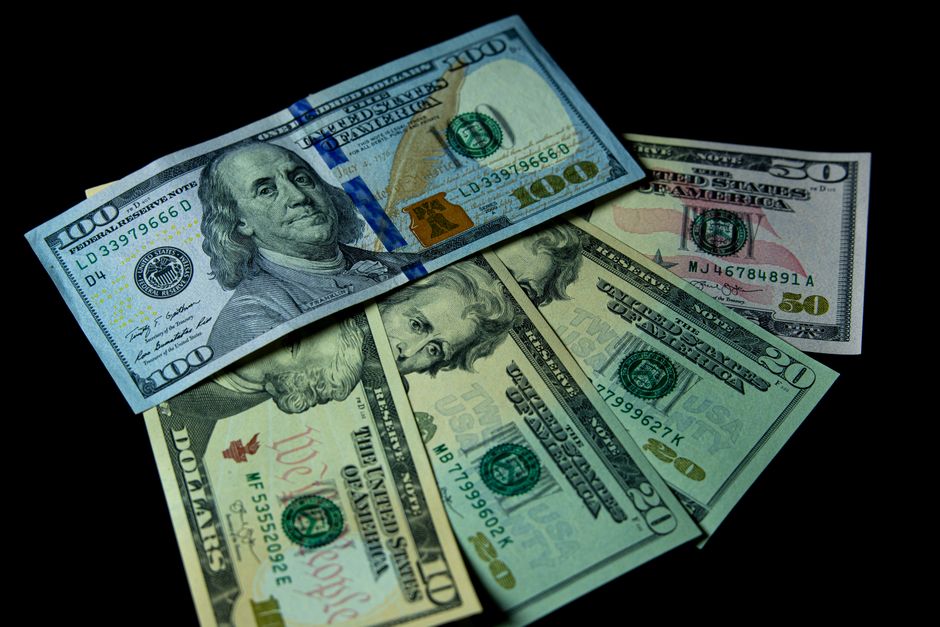 US dollar bills against a black background
