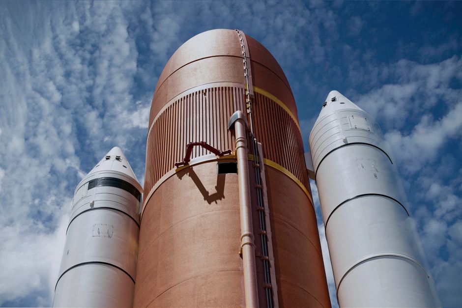 A rocket ascending vertically against a bright sky, illustrating a major public market debut.