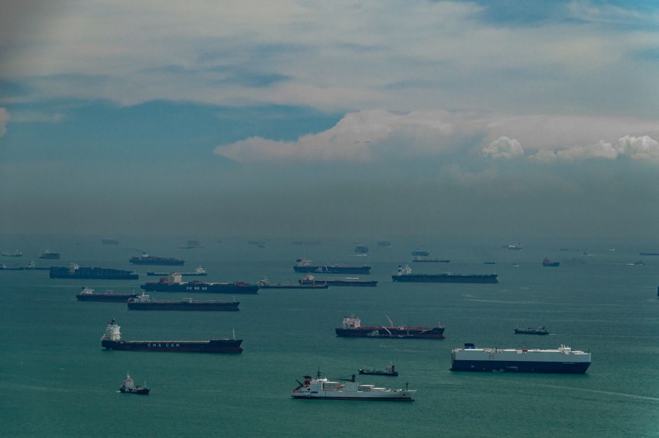 Aerial view of cargo ships navigating through a busy maritime strait.