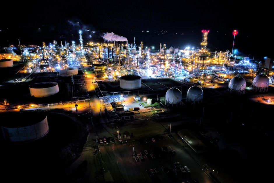An industrial refinery illustrates how energy infrastructure links geopolitics to global trade.