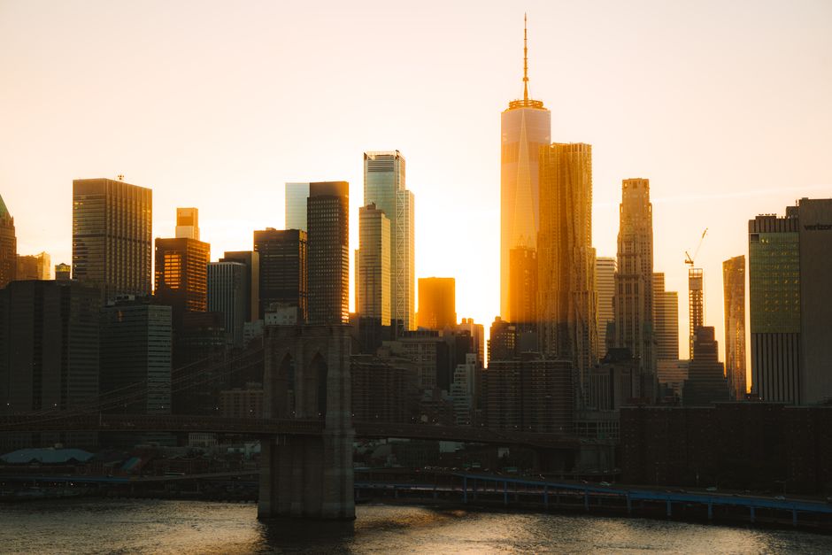 New York City financial district skyline at sunset, representing the close of a volatile trading session.