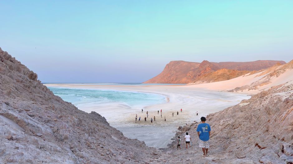 A scenic coastal view of Yemen's Socotra Island with rocky terrain meeting the sea, representing the Red Sea region near the Bab el-Mandeb Strait.