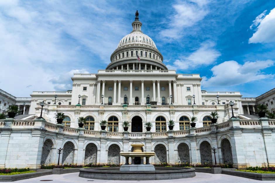 Exterior view of the US Capitol Building on a sunny day in Washington, DC, representing federal monetary and fiscal policy institutions
