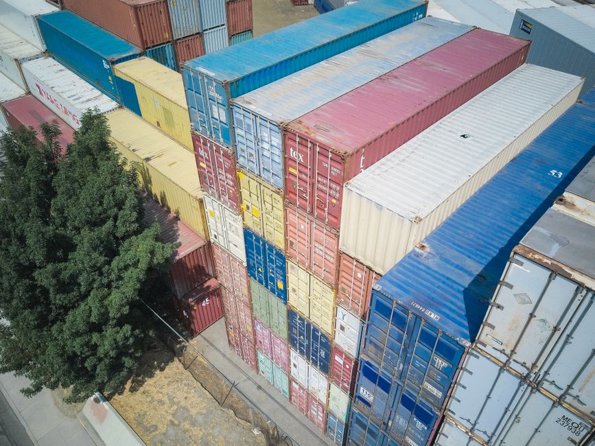Colorful shipping containers stacked at an industrial port