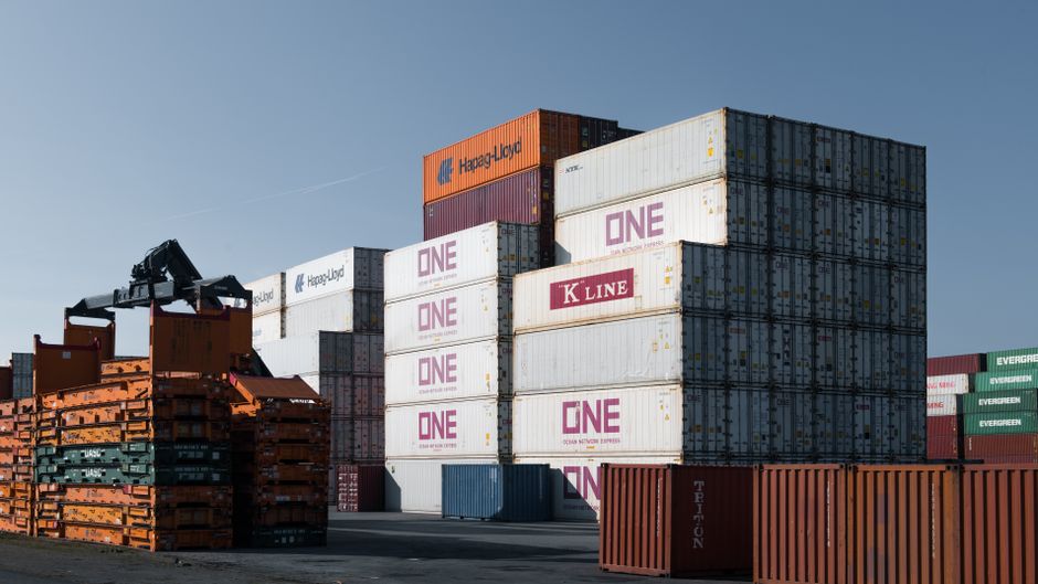 A large cargo ship navigating open ocean seen from above