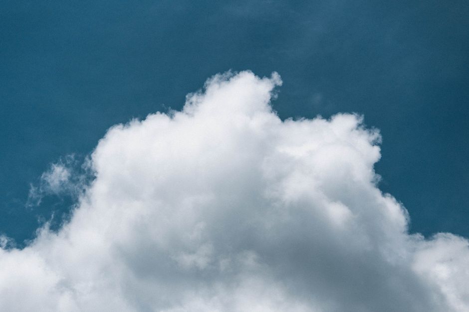 Fluffy white cloud against a clear blue sky