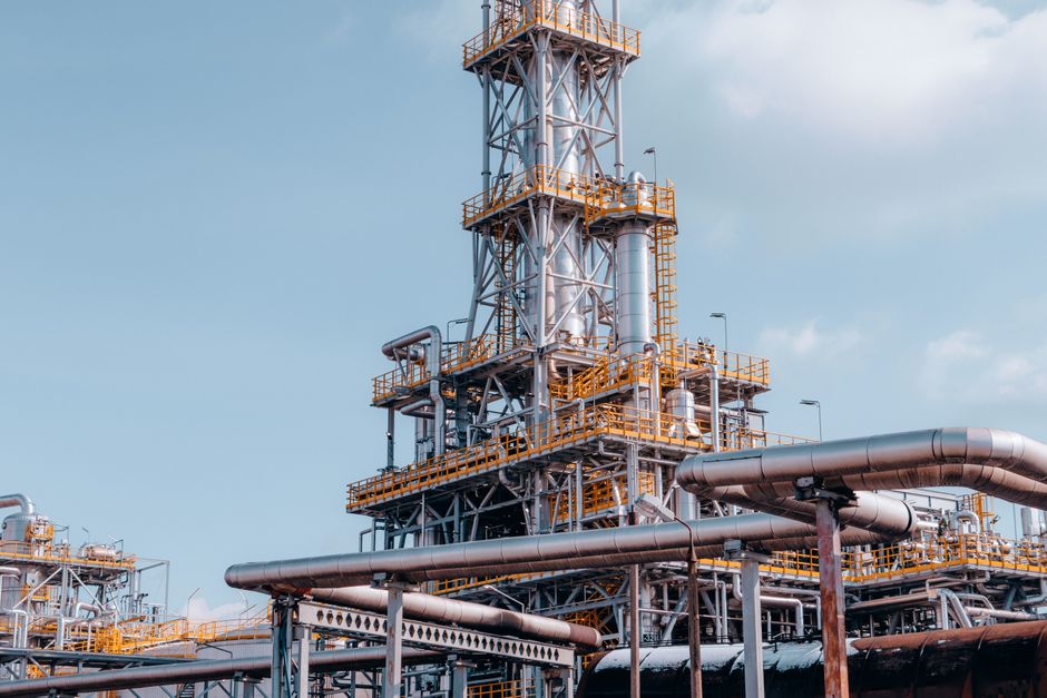 View of a large oil refinery plant with intricate pipelines, illustrating energy production capacity affected by sanctions.