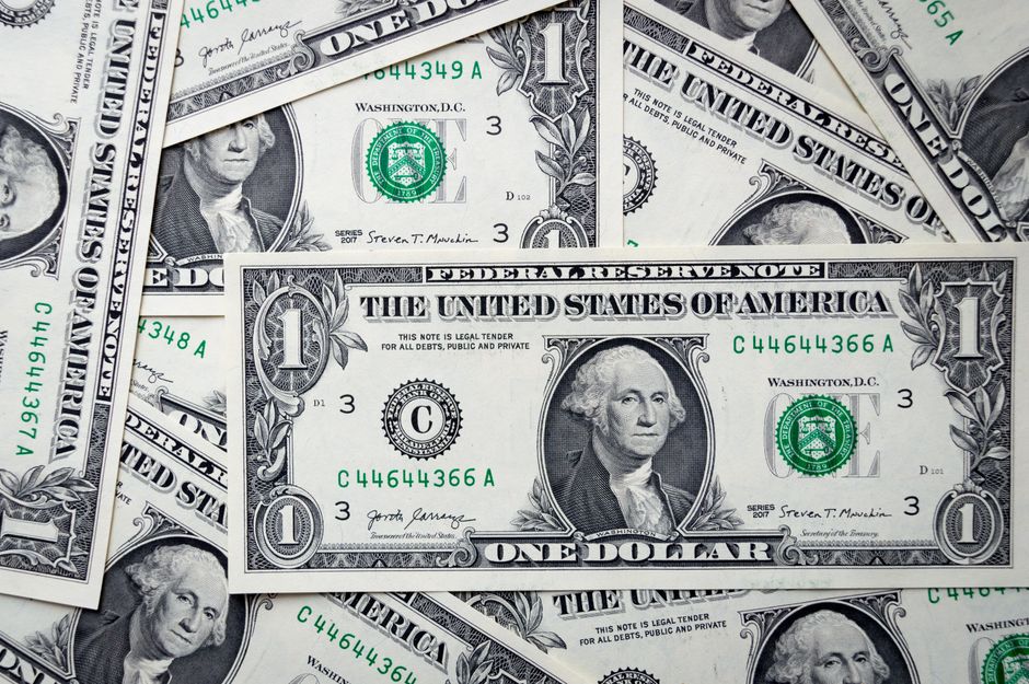 Close-up of U.S. one-dollar bills showing detailed currency design