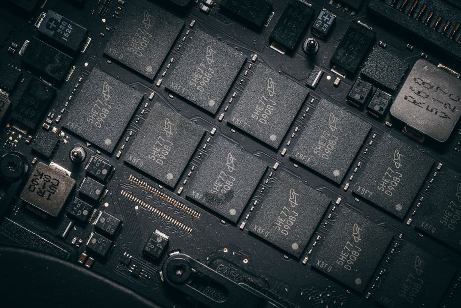 Close-up of electronic circuit board components showing microchips and semiconductor technology intricacies.