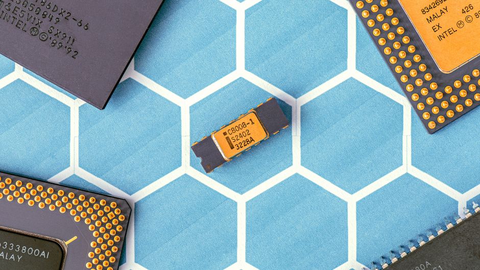 Close-up of various microprocessor chips on a blue hexagonal patterned surface, highlighting electronic semiconductor technology.