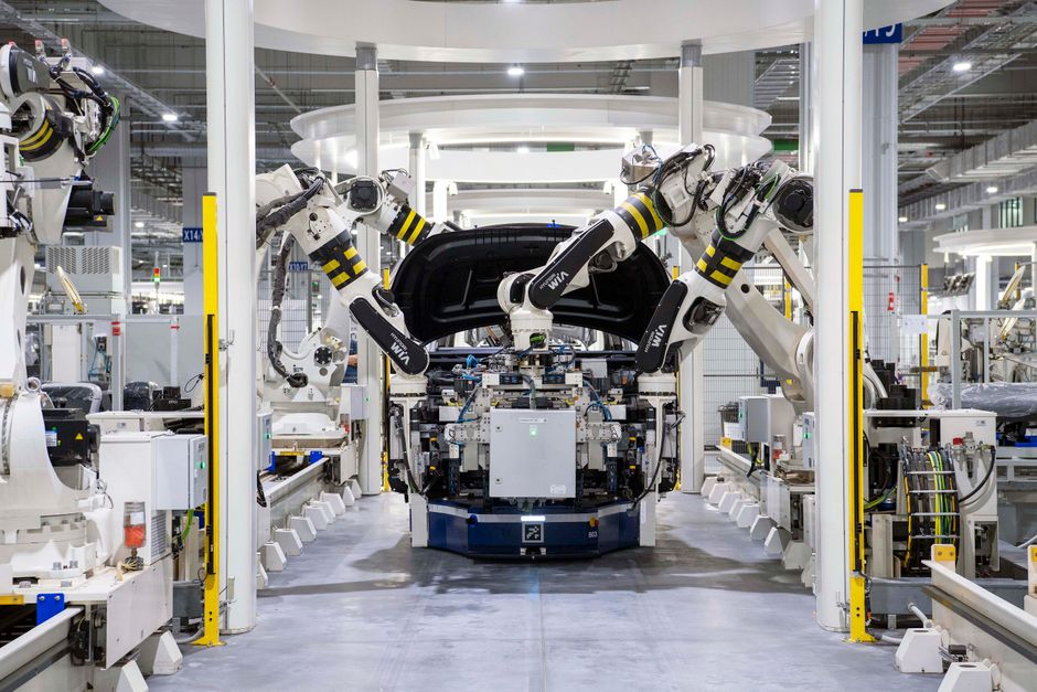 High-tech robots assembling a vehicle in a modern automated factory