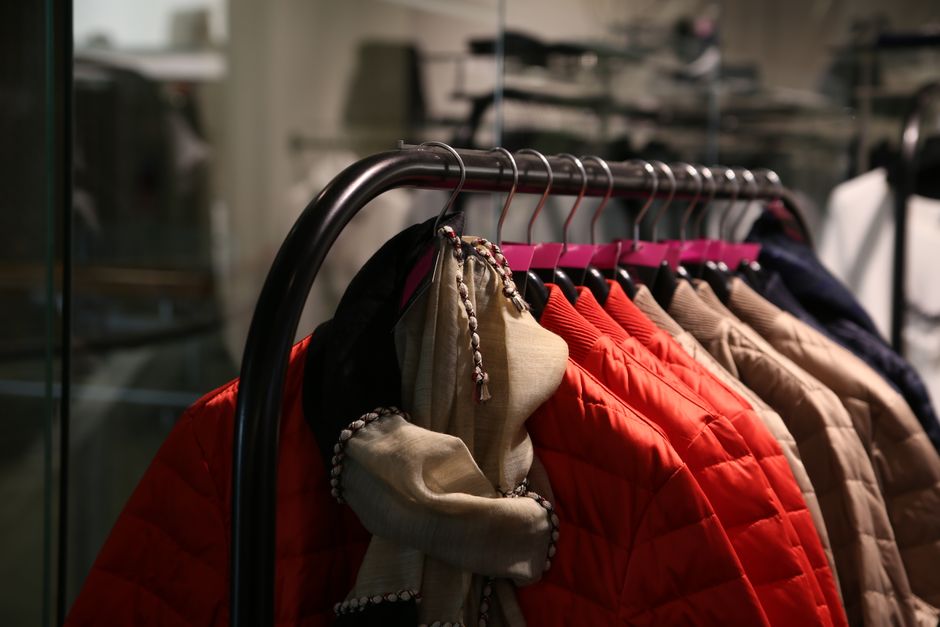 Colorful jackets hanging on a clothes rack in a stylish retail store