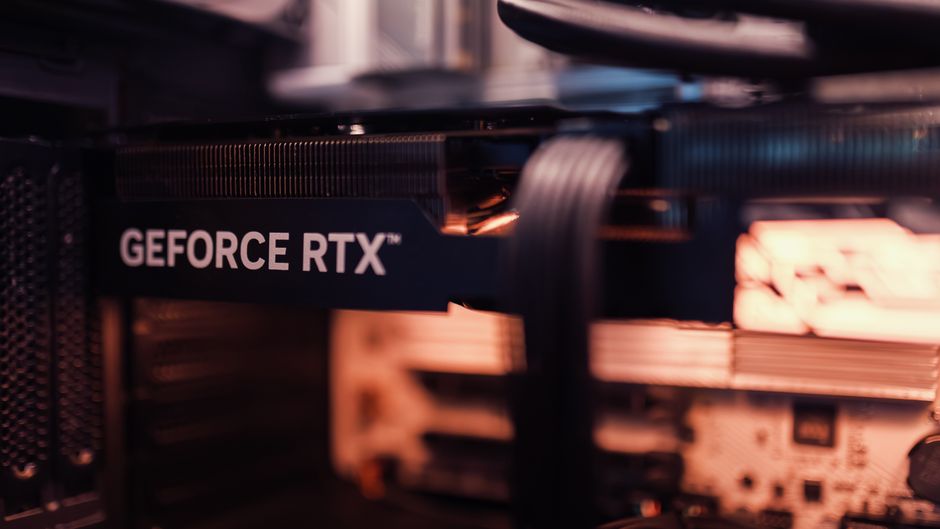 Close-up of a GeForce RTX graphics card installed in a computer, showing its cooling fans and circuitry.