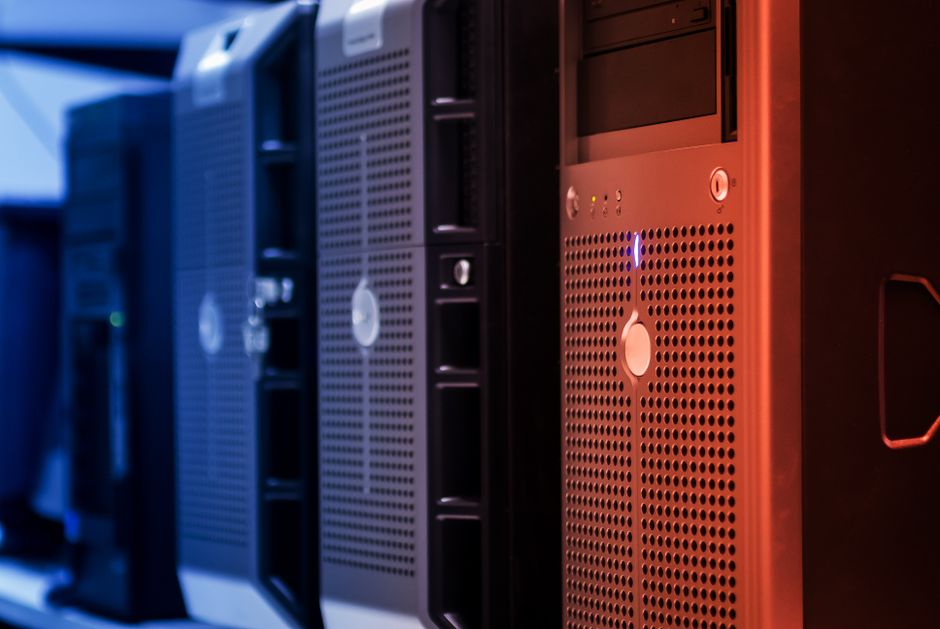 Close-up of server towers in a data center with blue and red lighting