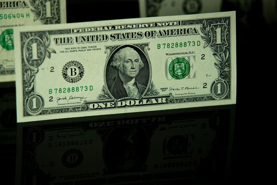 A dollar bill represents the monetary-policy and currency backdrop investors are weighing.