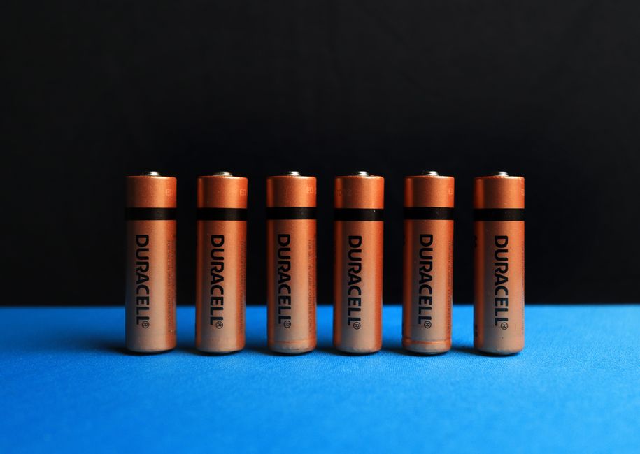 A lined up set of batteries with black and blue background.