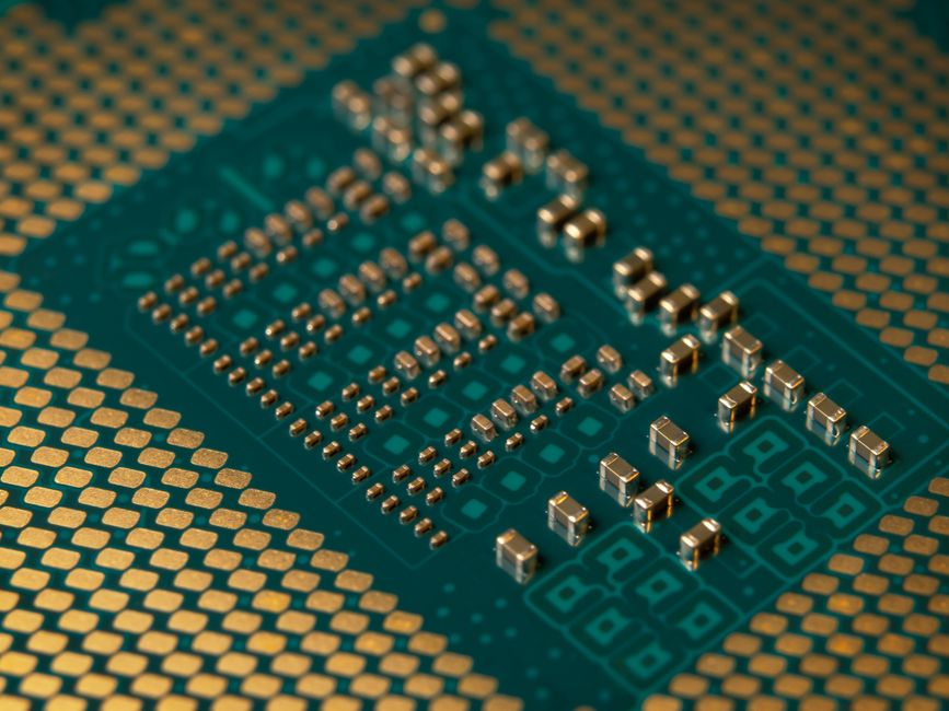 Close-up of a microprocessor circuit board with intricate gold circuitry