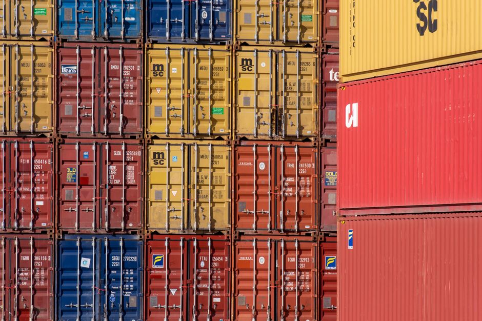 Colorful shipping containers stacked in a port for transport logistics