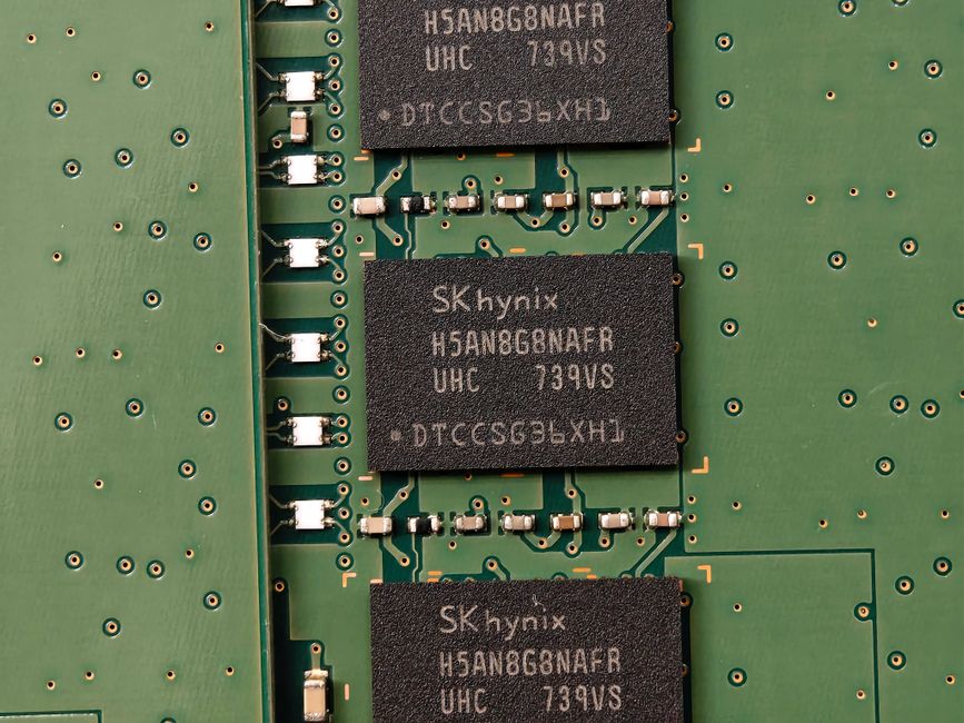 Detailed view of memory chips on a green circuit board featuring electronic components.