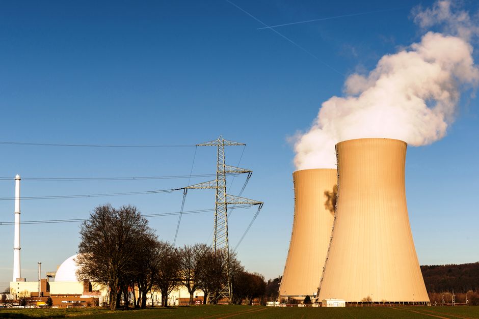 Nuclear power plant with cooling towers and electricity pylons