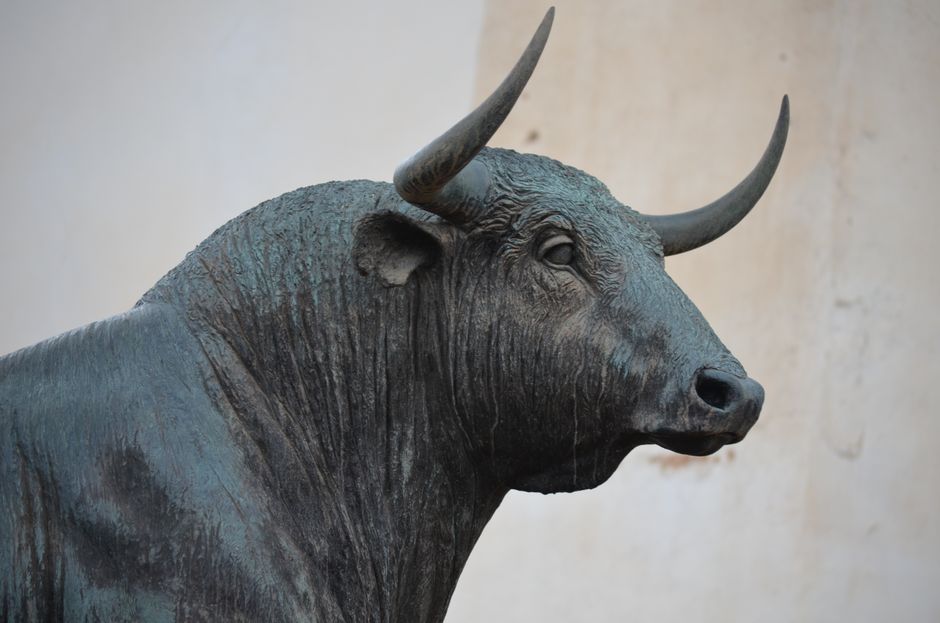 Close-up of a bronze bull statue symbolizing financial markets