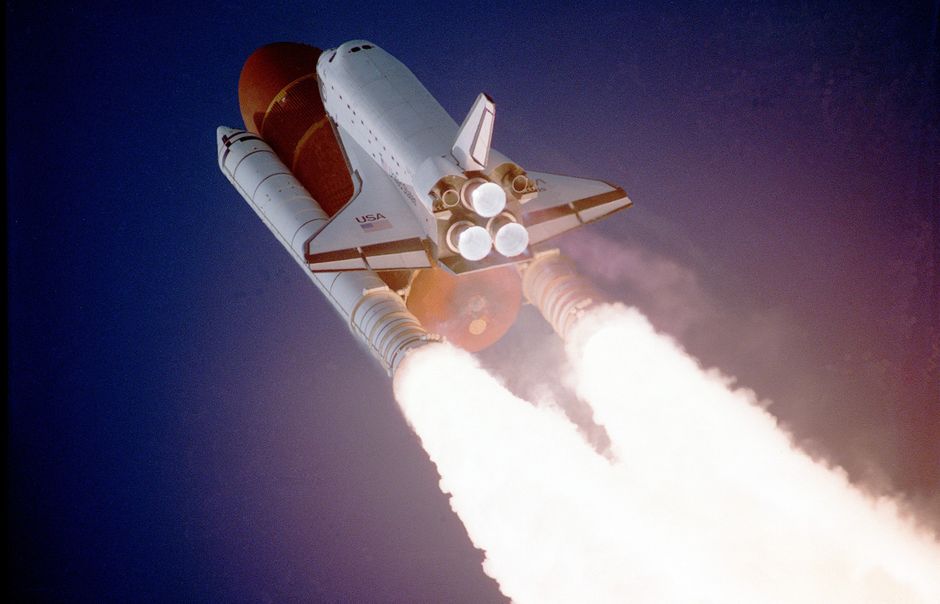 A space shuttle launching into space, showcasing powerful rocket engines and USA branding.