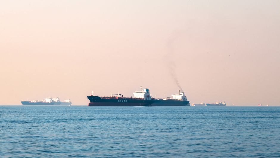 Industrial tanker ships navigate an open maritime route.