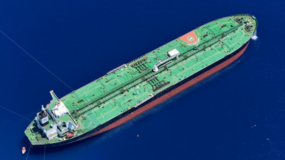 A cargo ship navigates a narrow international waterway, illustrating the strategic importance of shipping chokepoints.