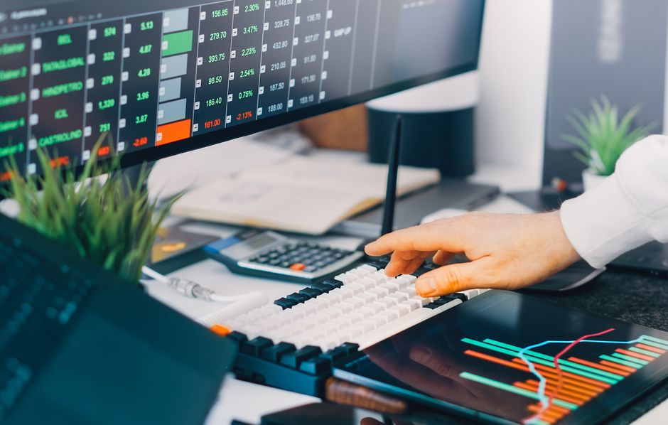Trading screens show market data as new equity supply and liquidity compete for investor attention.