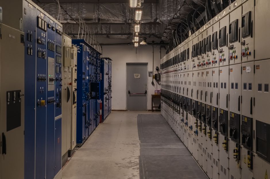 Industrial control room with electrical panels and equipment, representing data center and energy infrastructure.