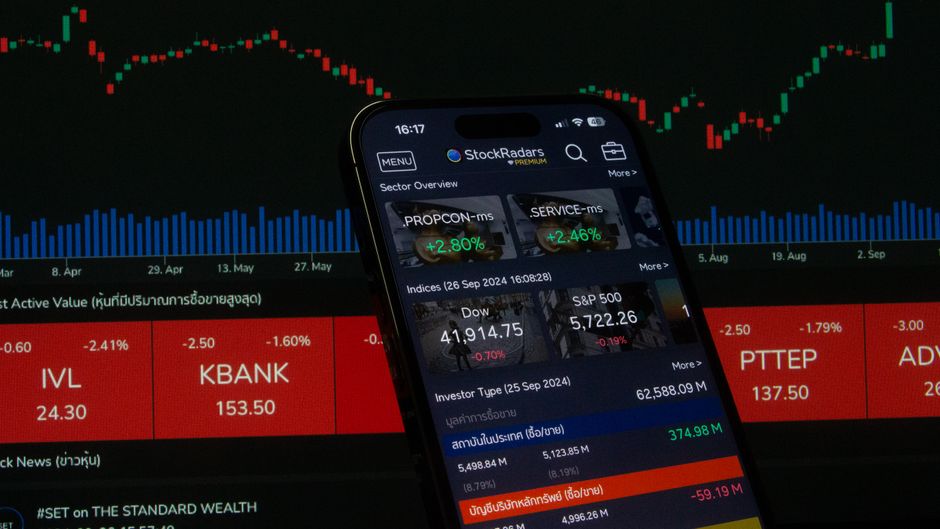 A digital stock trading app interface with investment charts and market trends displayed.
