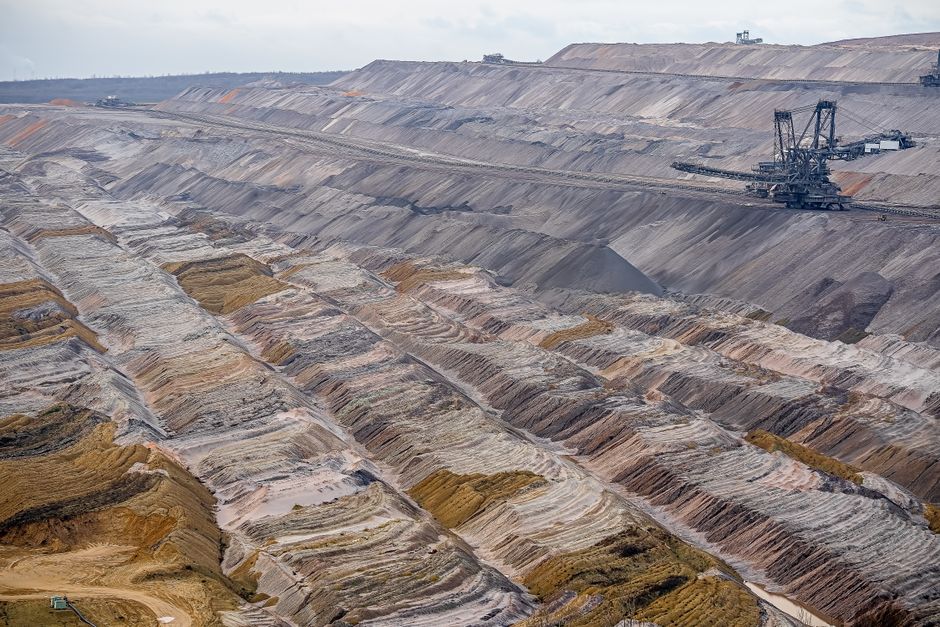 Aerial view of a large open-pit mine with layered terrain, echoing CopperTech Metals' Zambian copper operations
