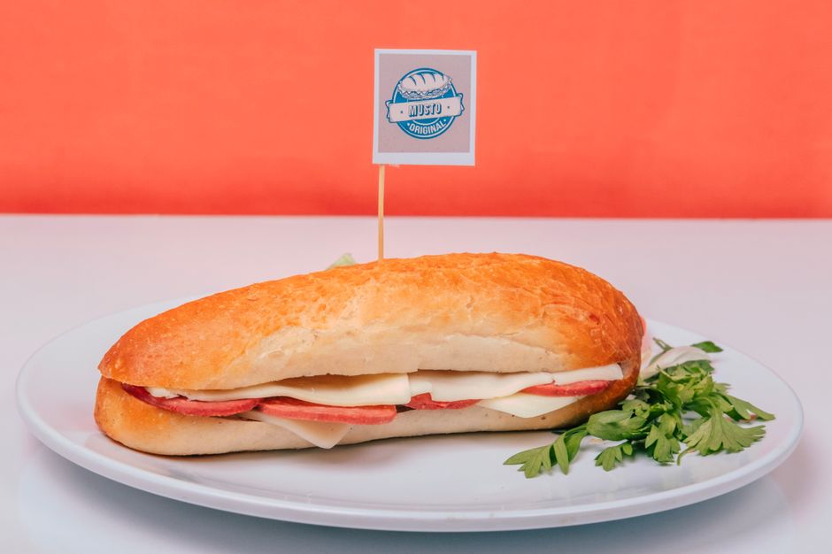 A fresh sub sandwich with meats and cheese on a plate