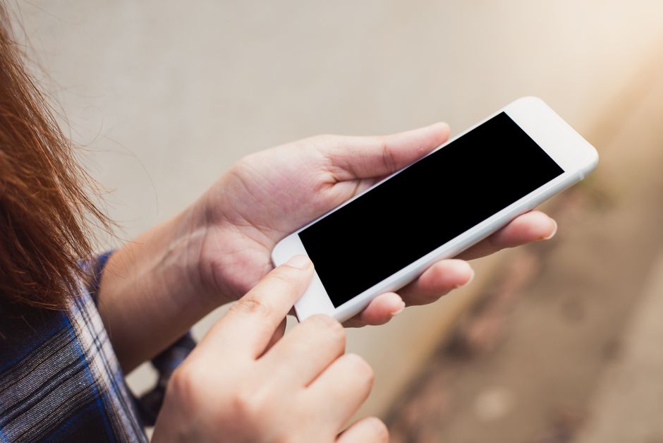 Person holding and using a smartphone