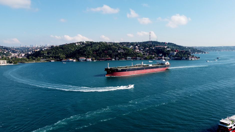 Aerial view of a cargo ship navigating through a strait