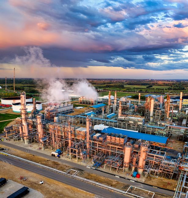 An aerial view of an oil refinery complex at sunset